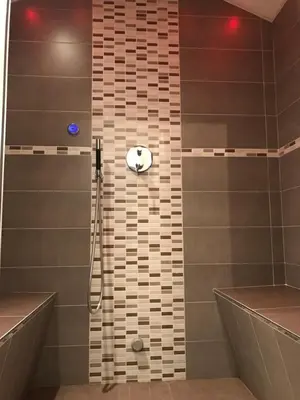 a bathroom with a shower with a tub and a sink at Appartamento Piè in Canazei