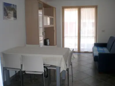 a living room with a white table and chairs at Anna Apartment in Pozza di Fassa