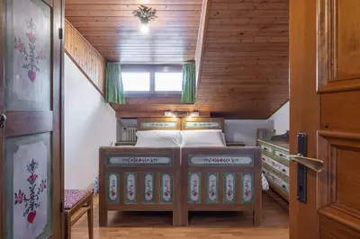 a bedroom with a bunk bed in a house at ATTICO Lodge in Cortina dʼAmpezzo
