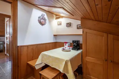 a small table in a room with a table sidx sidx sidx at ATTICO Lodge in Cortina dʼAmpezzo