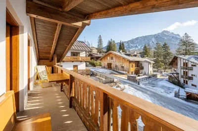 a balcony with a view of the mountains at ATTICO Lodge in Cortina dʼAmpezzo