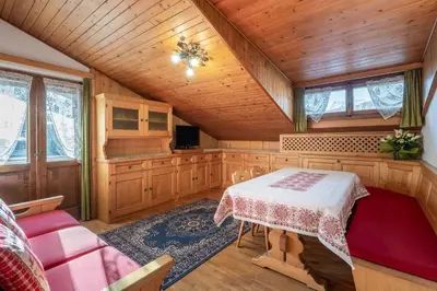 a dining room with a table in a house at ATTICO Lodge in Cortina dʼAmpezzo