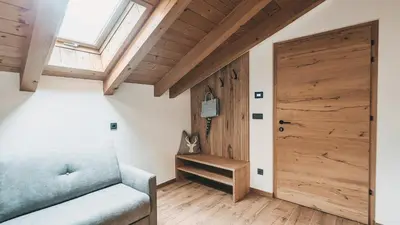 a bedroom with a bed and a couch and a window at Jägerheim in Vilpiano