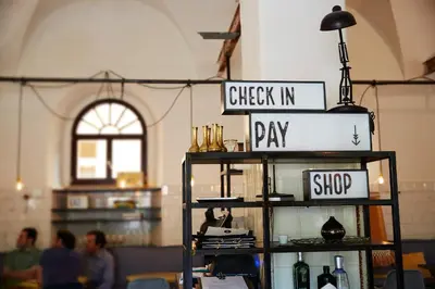 a shelf with a sign that says check in and pay at Alter Schlachthof in Bressanone