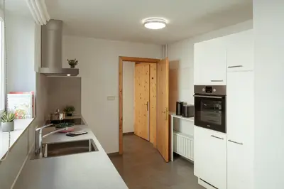 a kitchen with white cabinets and a counter top at Alter Schlachthof in Bressanone