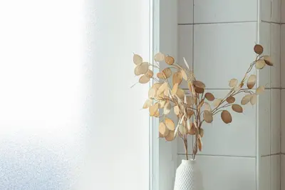 a white vase with a plant in it at Alter Schlachthof in Bressanone