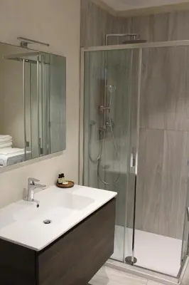 a bathroom with a sink and a shower at Apartments Rathaus 008 - Municipio 008 in Bolzano