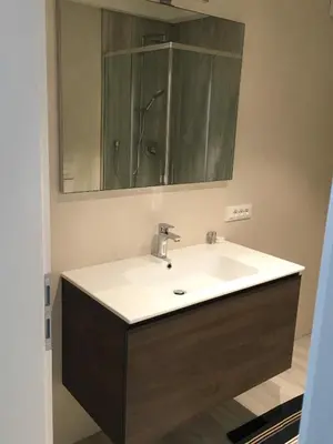 a bathroom with a sink and a mirror at Apartments Rathaus 008 - Municipio 008 in Bolzano