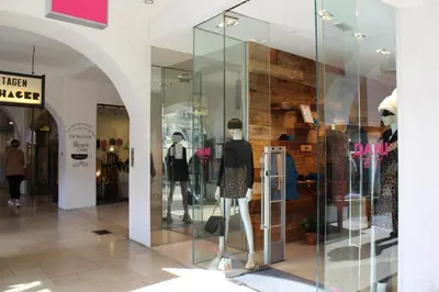 a display window of a store with mannequins at Apartments Rathaus 008 - Municipio 008 in Bolzano