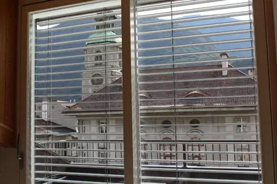 a view of a large building through a window at Apartments Rathaus 008 - Municipio 008 in Bolzano
