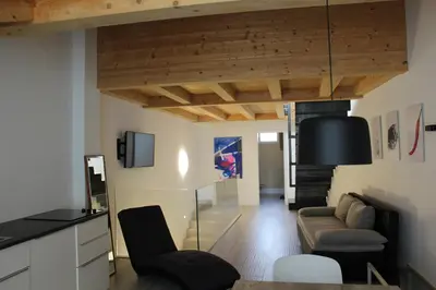 a living room with a couch and a chair at Apartments Rathaus 008 - Municipio 008 in Bolzano