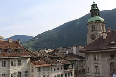 a group of buildings with a tower with a clock at Apartments Rathaus 008 - Municipio 008 in Bolzano