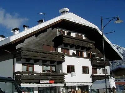 a large building with a snow covered roof at Grohmann in Campitello di Fassa