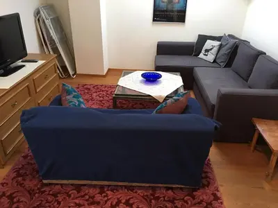 a living room with a couch and a table at Grohmann in Campitello di Fassa