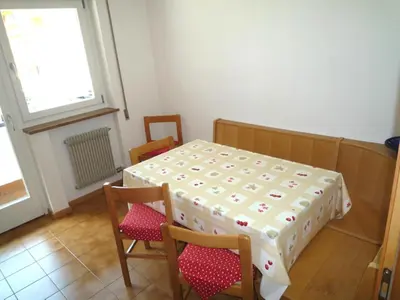 a room with a table and two chairs and a window at Grohmann in Campitello di Fassa