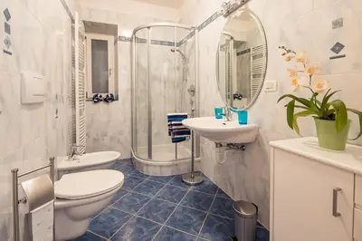 a bathroom with a toilet and a sink and a shower at Haus Dorfblick in Caldaro