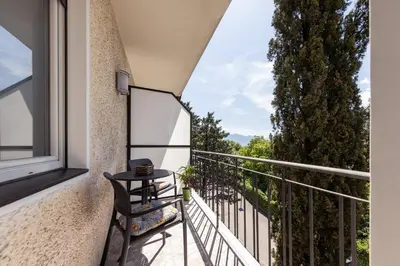 a balcony with a table and a chair on it at Haus Dorfblick in Caldaro