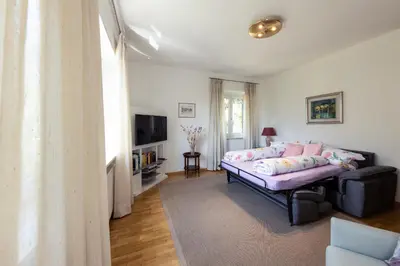a living room with a couch and a tv at Haus Dorfblick in Caldaro