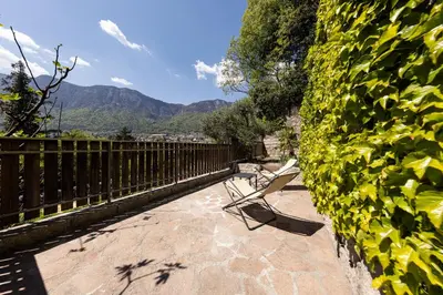 a bench sitting on a patio next to a fence at Haus Dorfblick in Caldaro
