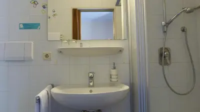 a bathroom with a sink and a shower at Pension Runer in Terlano