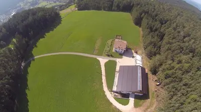 an aerial view of a barn in a field at Parlunkhof in Castelrotto