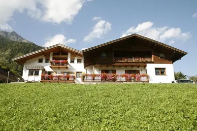 a house on top of a hill with a green field at Residence Karnutsch in Santa Valburga St. Walburg