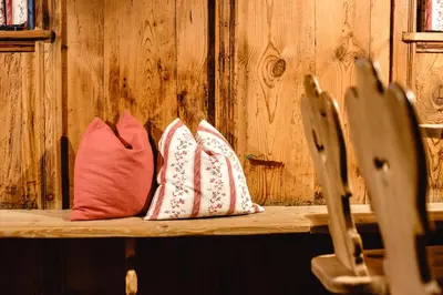 two pillows sitting on top of a wooden bench at Residence Karnutsch in Santa Valburga St. Walburg