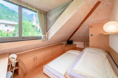 a bedroom with a bed and a window at Haus Piger in Termeno