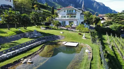 a house on a hill next to a river at Burgunderhof in Montagna