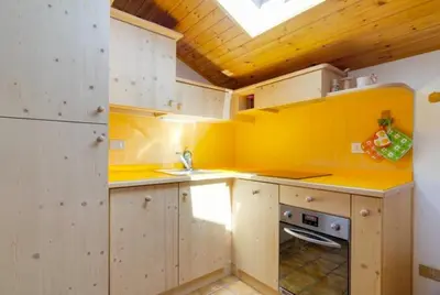 a bedroom with a bed and a skylight at Appartamento Saslonch 21 in Moena