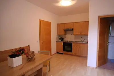 a kitchen with wooden cabinets and a wooden table at Biohof Niedereben in Rablà