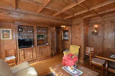 a living room with wood paneling and a television at Cá Enrosadira Piano Secondo in San Vito di Cadore