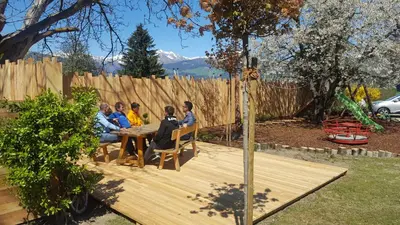 a group of people sitting around a wooden table at Appartements Schusterhof in Naz-Sciaves