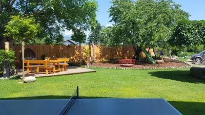 a backyard with a ping pong table and a picnic table at Appartements Schusterhof in Naz-Sciaves