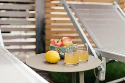 a bowl of apples and two glasses of orange juice at Hotel Garni Sirmian in Merano