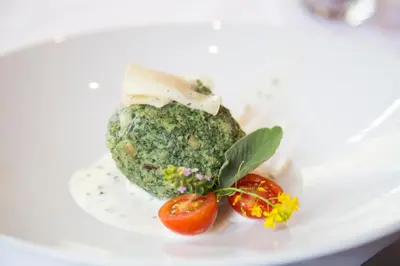 a plate of food with tomatoes on a white plate at Unterer Obereggerhof in San Leonardo in Passiria