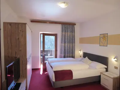 a bedroom with a bed and a table with candles at Sonnhof in Trodena