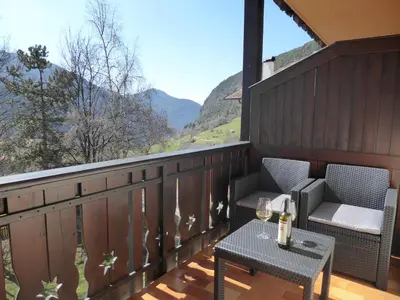 a living room with a red couch and a window at Sonnhof in Trodena