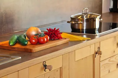 a cutting board with tomatoes and other vegetables on a counter at Ban Rutzner in SantʼAndrea in Monte