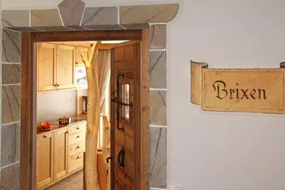 a kitchen with a sign that reads chicken on the wall at Ban Rutzner in SantʼAndrea in Monte