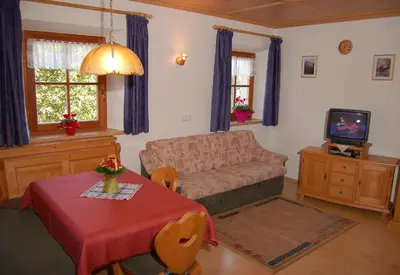 a living room with a couch and a table at Vilahof in San Vigilio Di Marebbe