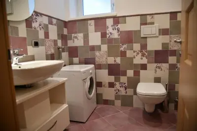 a bathroom with a sink and a toilet and a sink at Chalet Villa Bianca in Tesero