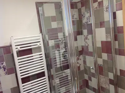 a shower with a glass door in a bathroom at Chalet Villa Bianca in Tesero