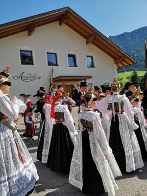 a group of people in folk costumes in front of a building at Apartments Ansciuda in Ortisei