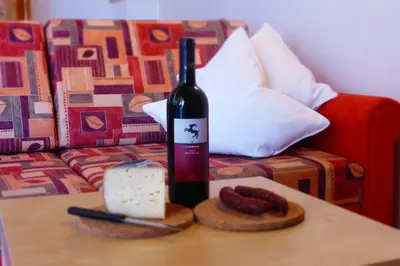 a bottle of wine sitting on top of a table at Apartments Ansciuda in Ortisei