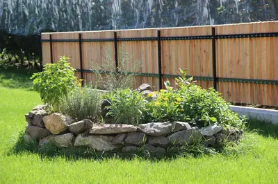 a rock garden in a yard with a fence at Praitladhof in Lana