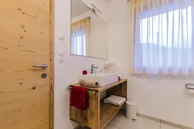 a bathroom with a sink and a mirror at Praitladhof in Lana