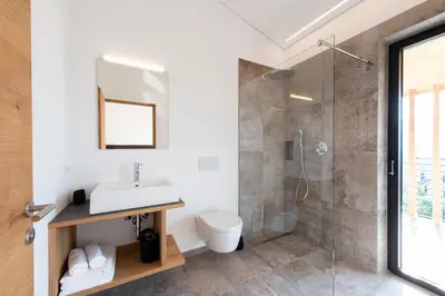 a bathroom with a sink and a shower at Villa Montis Exclusive Holiday Apartments in Eppan with Spectacular Views of Dolomites and Bolzano Area in Appiano sulla Strada del Vino