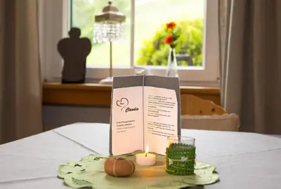 a candle and a box on top of a table at Haus Claudia B&B in Nova Levante
