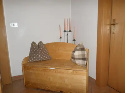 a wooden chest with some pillows on top of it at Haus Claudia B&B in Nova Levante
